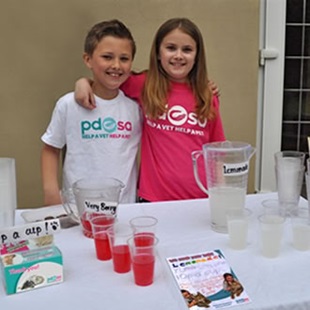 Two young people wearing PDSA t-shirts at one of our events.
