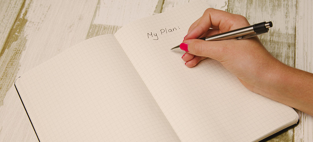 Close up of someone writing an event plan