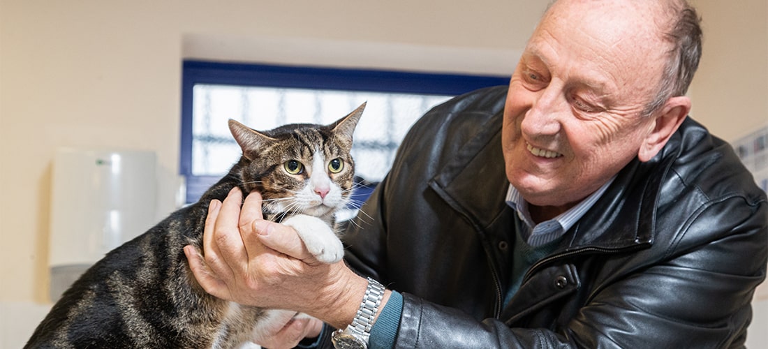 Toby the cat reunited with his smiling owner