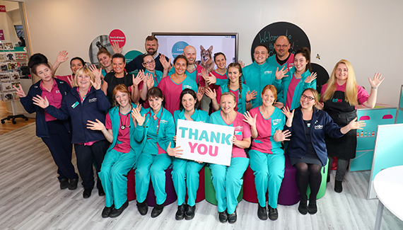 Group of PDSA employees holding up a thank you sign