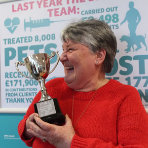 Val, a PDSA volunteer fundraiser, holds her volunteering award.
