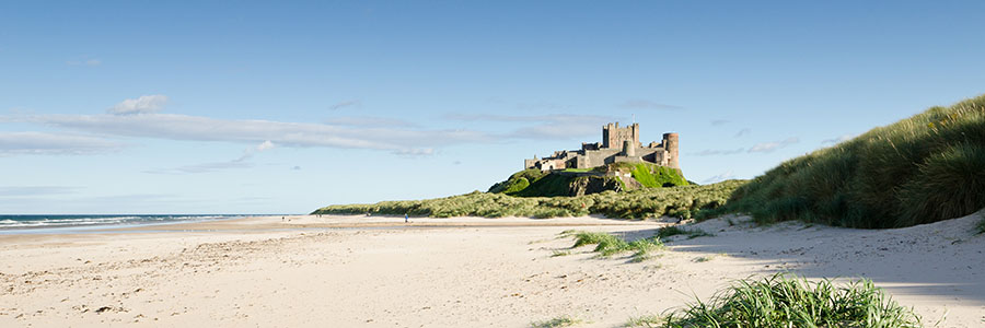 Photo of Bamburgh Beach on a sunny day