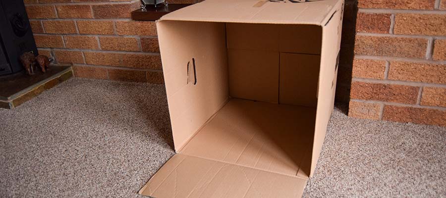 Cardboard box in space for den